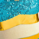 close-up of teal princess costume with gold sequins and mesh detailing