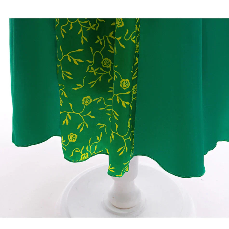 close-up of emerald green princess dress hemline with gold trim