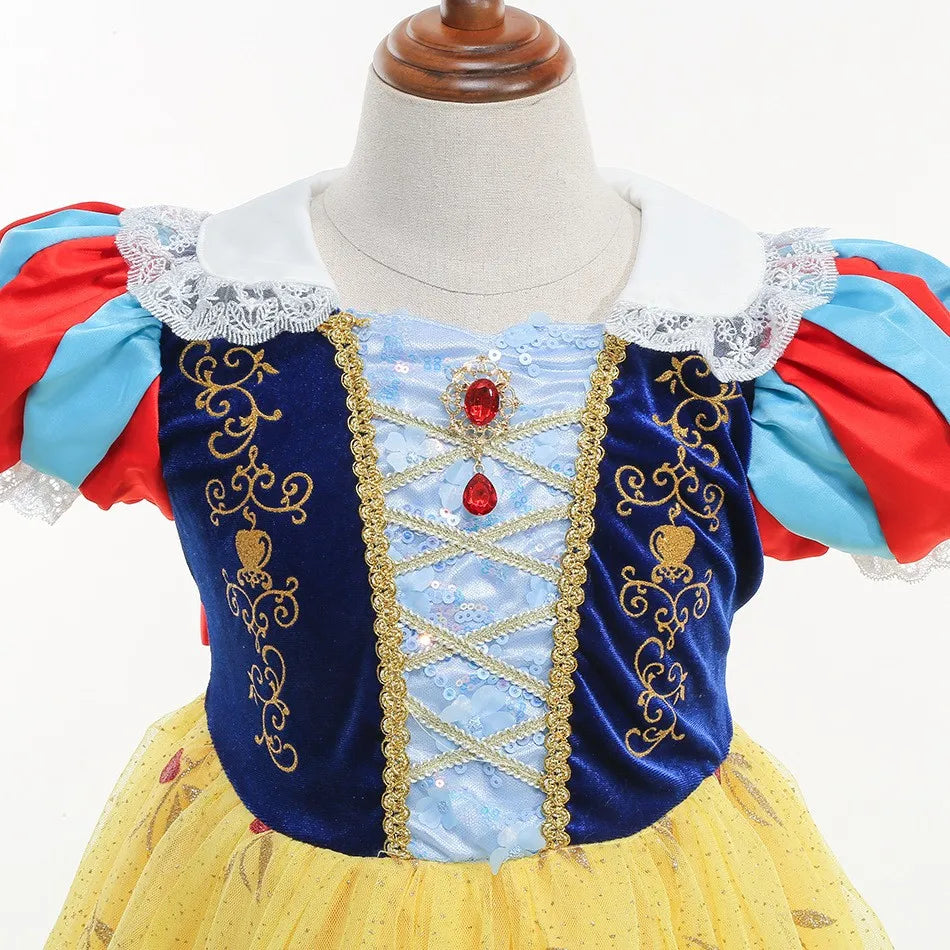close-up of blue bodice with golden embroidery and gemstone accents